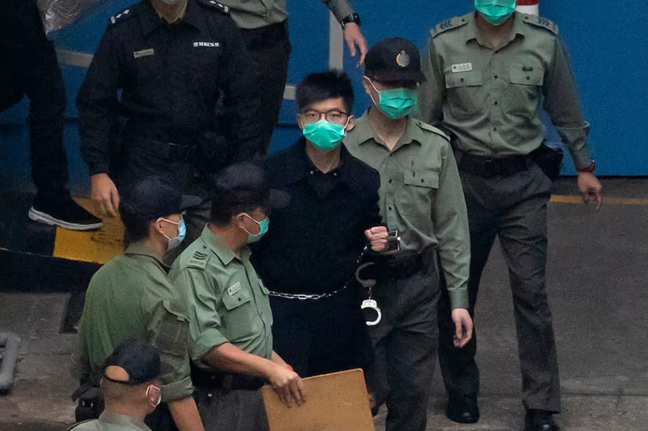 4 March 2021: Joshua, in handcuffs, is escorted by Correctional Services officers to a prison van.